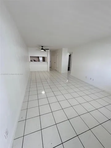 a view of empty room with cabinet and window