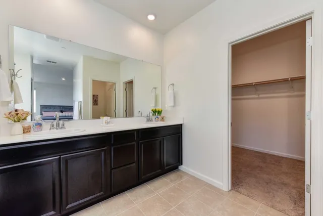 a bathroom with a double vanity sink and a mirror