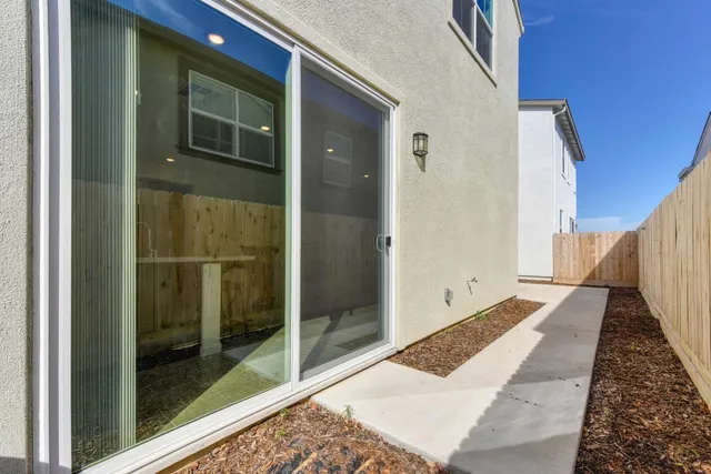 a view of a hallway with wooden floor and glass door