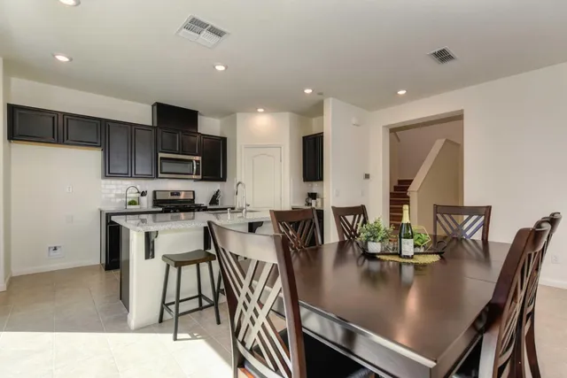 a view of kitchen with cabinets table and chairs