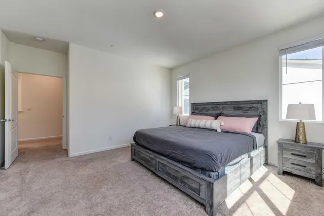 a bedroom with a bed and a night stand