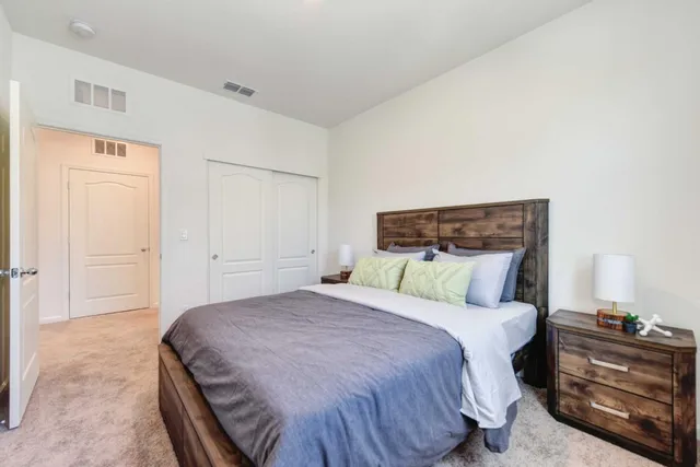 a bedroom with a bed and a lamp