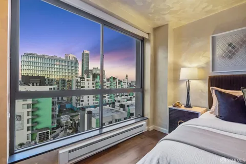 a bedroom with furniture and a large window