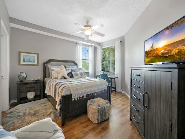 a bedroom with a bed and a flat screen tv