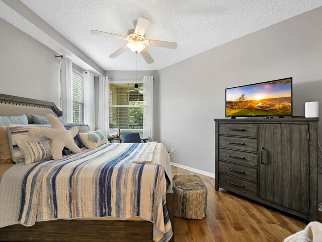a bedroom with two beds and a flat screen tv