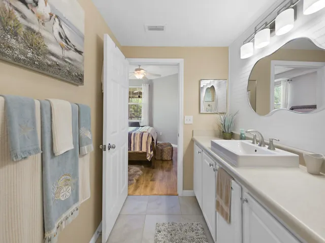 a en suite bathroom with a double vanity sink a mirror and shower