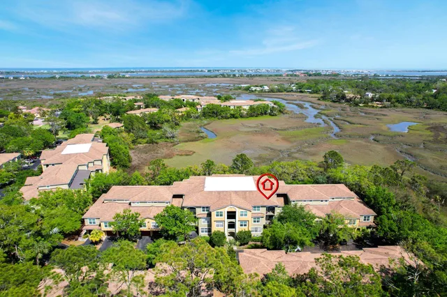 an aerial view of a house with a yard and lake view