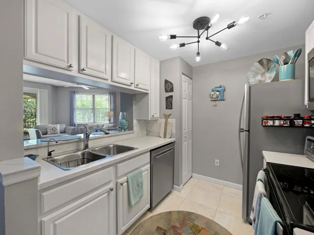 a kitchen with stainless steel appliances granite countertop a sink and a refrigerator