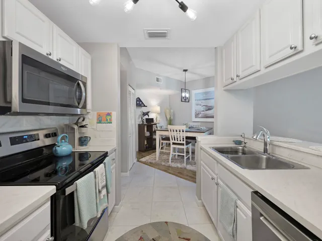 a kitchen that has a sink and a stove top oven