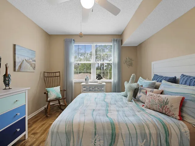 a bedroom with a large bed and a window