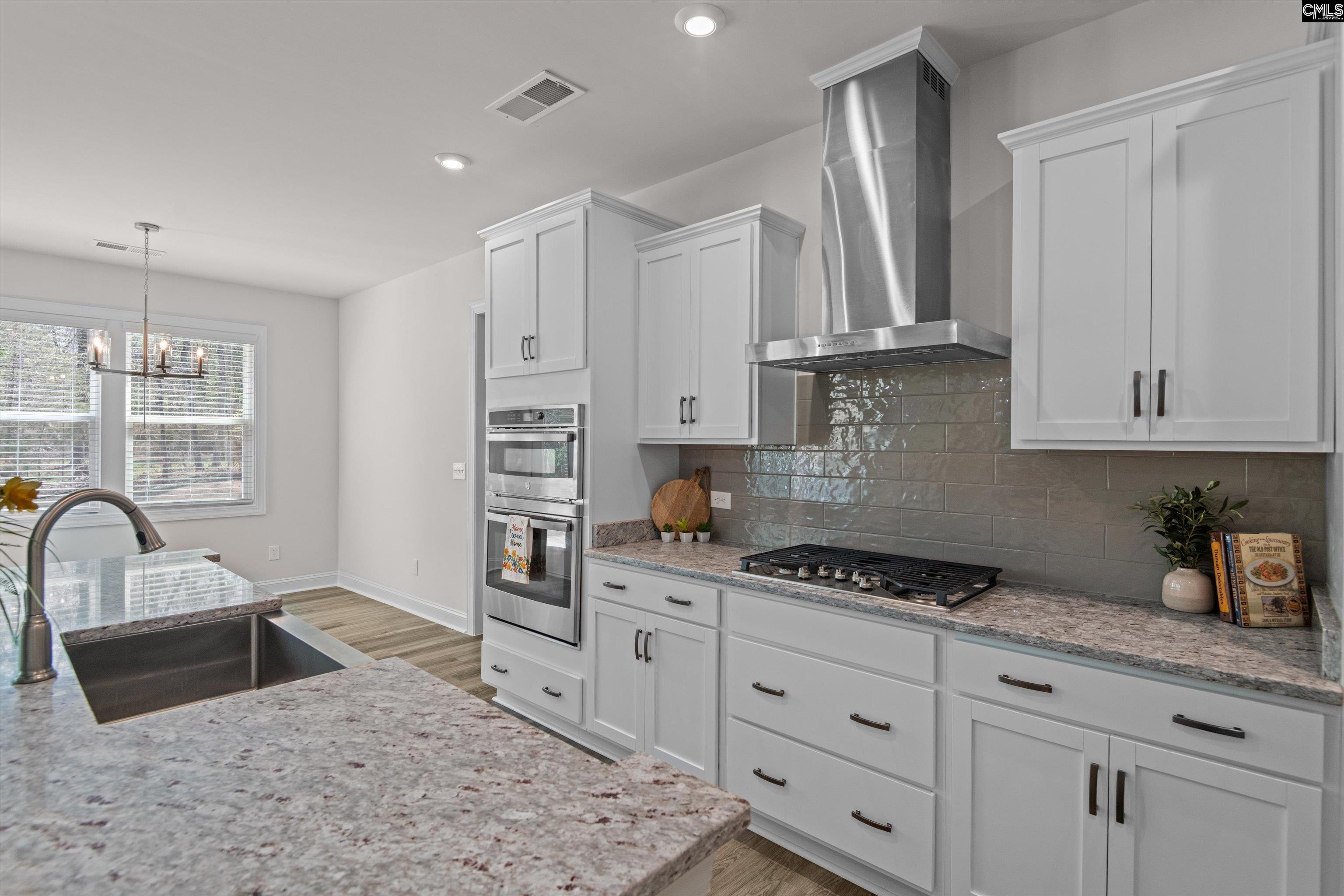 558 Wild Ginger Loop Irmo, SC 29063 - Photo 15 of 42 a kitchen with granite countertop a sink stainless steel appliances and cabinets