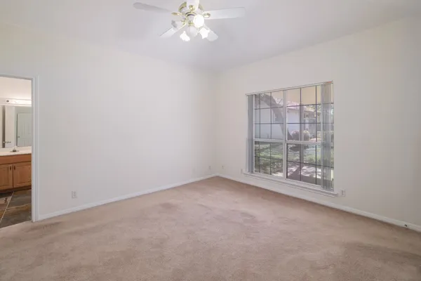 an empty room with a empty space and windows