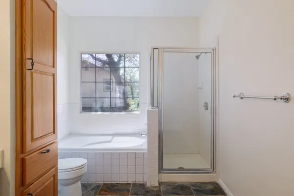 a bathroom with a toilet and a shower