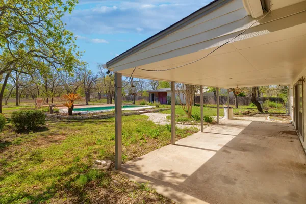a view of a house with backyard area and garden