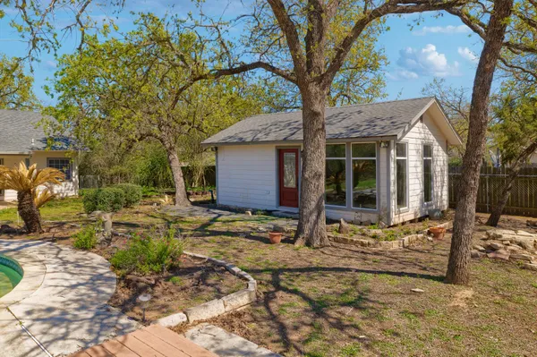 a view of house with backyard of house