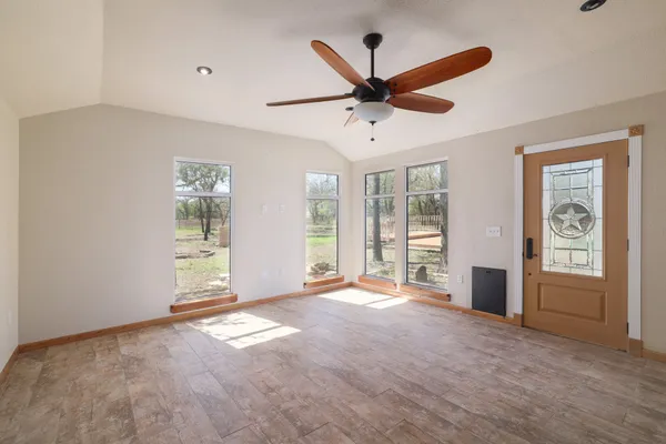 a view of a livingroom with a ceiling fan and window