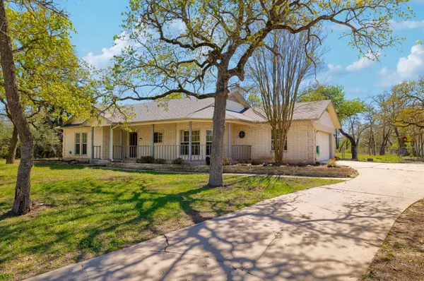 a view of a house with a yard and tree s