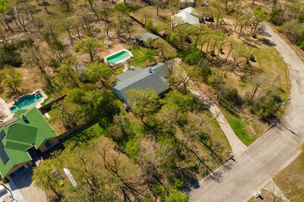 an aerial view of a house with a yard