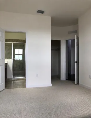 a view of an empty room with glass door