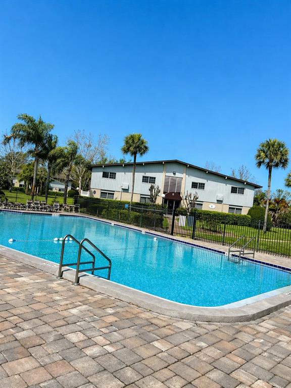 1695 Lee Road, Unit C206 Winter Park, FL 32789 - Photo 17 of 18 a view of a swimming pool with a lounge chairs