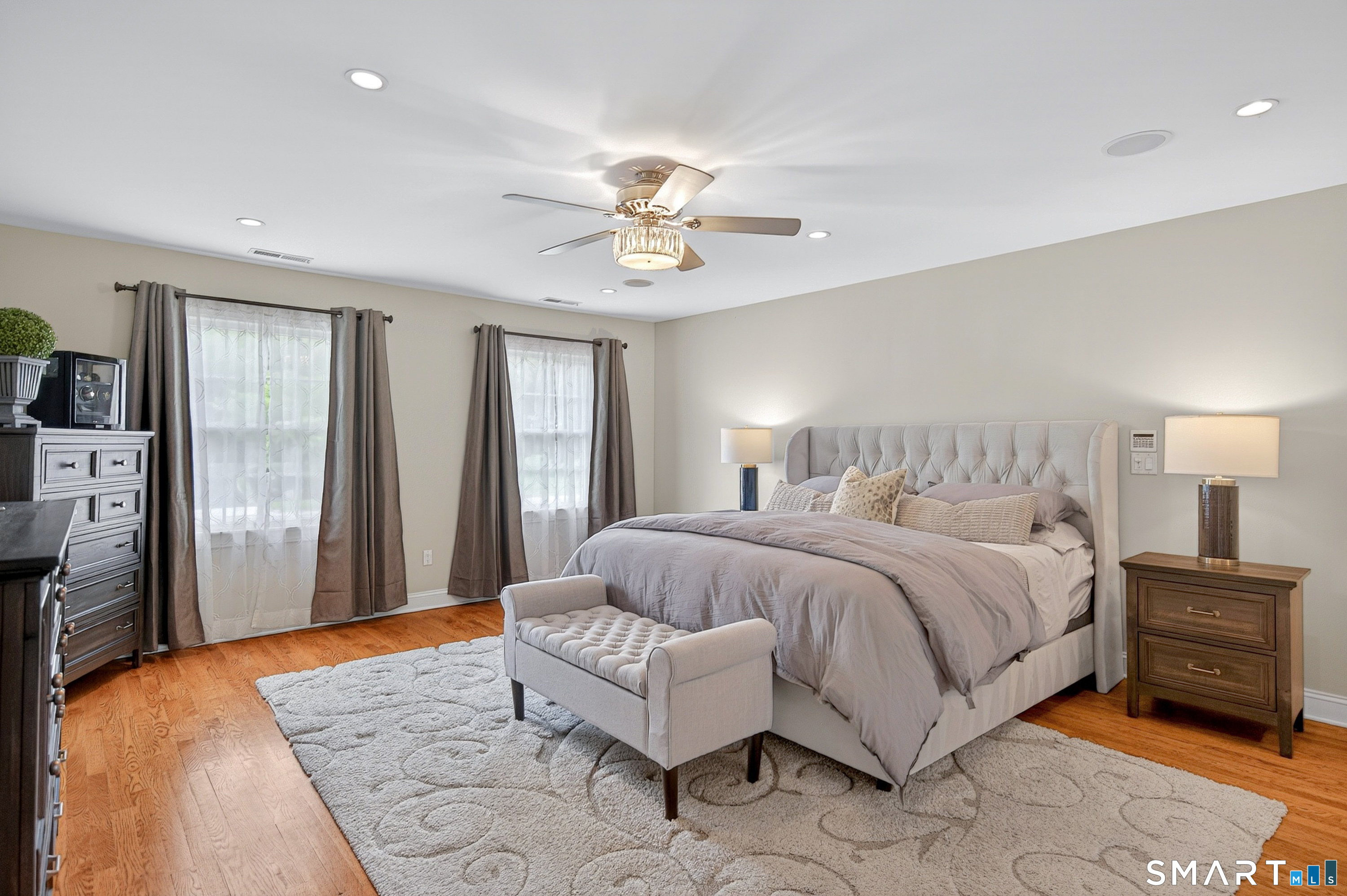 16 Farm Meadow Road Newtown, CT 06470 - Photo 18 of 40 Spacious primary bedroom with hardwood flooring, recessed lighting, and serene natural light.