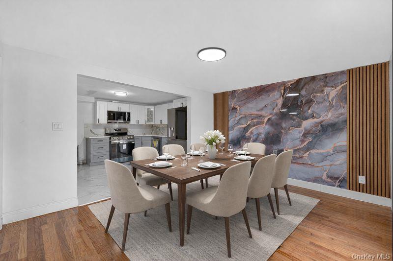 136-03 220th Street Queens, NY 11413 - Photo 1 of 27 a view of a dining room with furniture and wooden floor