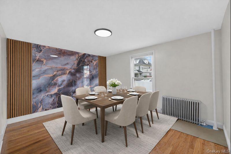 136-03 220th Street Queens, NY 11413 - Photo 12 of 27 a view of a dining room with furniture and wooden floor