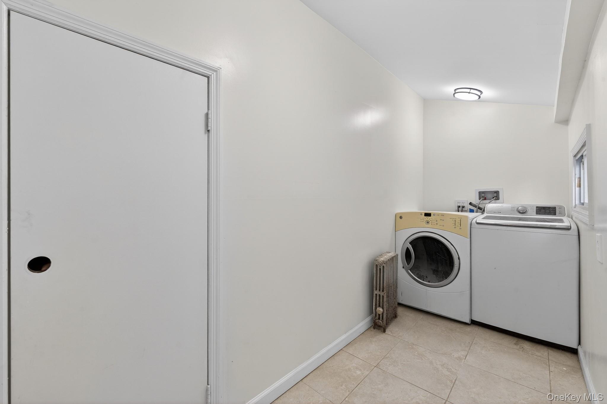 136-03 220th Street Queens, NY 11413 - Photo 13 of 27 a utility room with dryer and washer