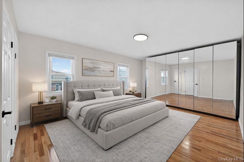 136-03 220th Street Queens, NY 11413 - Photo 17 of 27 a bedroom with a bed and a night stand