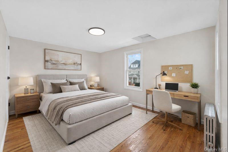 136-03 220th Street Queens, NY 11413 - Photo 5 of 27 a bedroom with a bed and wooden floor