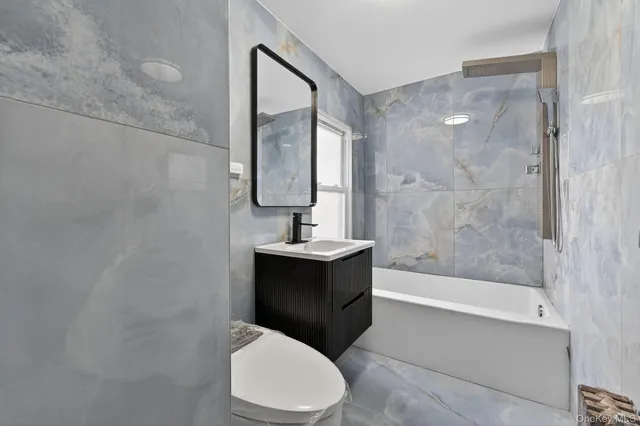 a kitchen with granite countertop a refrigerator stove top oven and sink