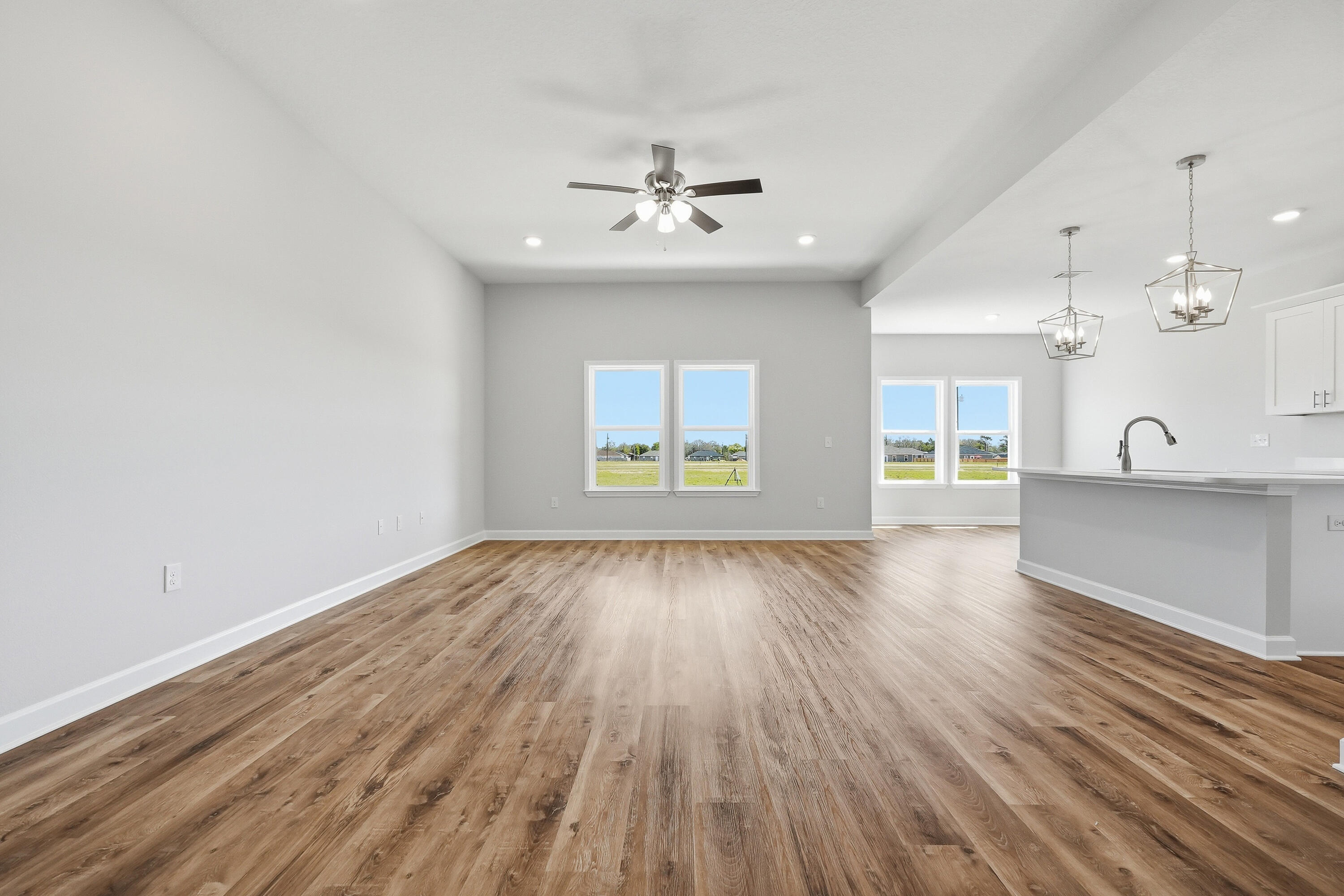 6114 Mildreds Way Crestview, FL 32539 - Photo 3 of 24 wooden floor in an empty room with a window