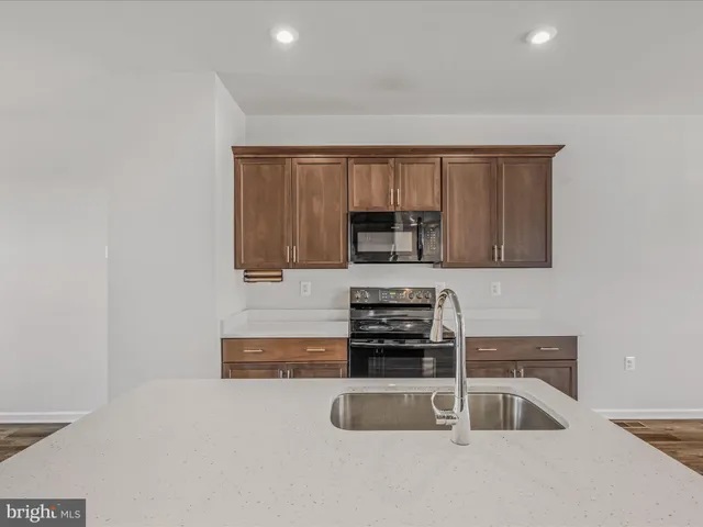 a kitchen that has a sink and a stove top oven