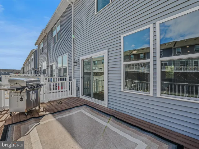 a view of a house with a large window and wooden fence