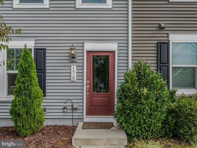 a view of a house with potted plants