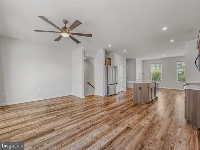 a view of a livingroom with a hardwood floor and a ceiling fan