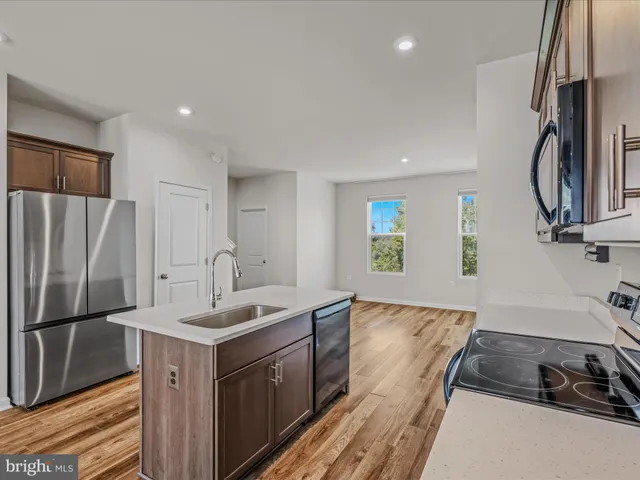 a kitchen with a sink stove and refrigerator