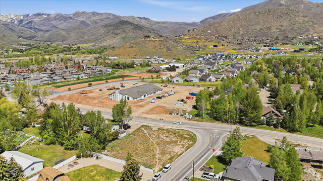 123 West 1050th North, Unit 41 Midway, UT 84049 - Photo 3 of 22 Expansive development site featuring active construction, surrounding residential properties, and paved roadways