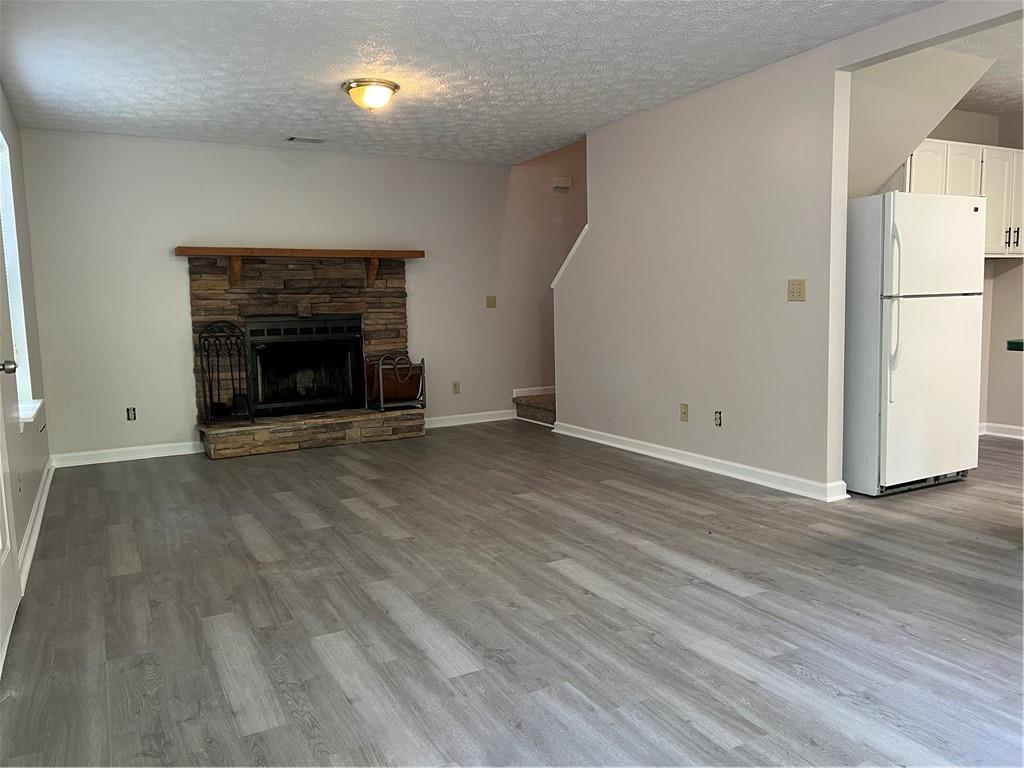 129 Pine Road Dahlonega, GA 30533 - Photo 11 of 27 a view of empty room with wooden floor and fireplace