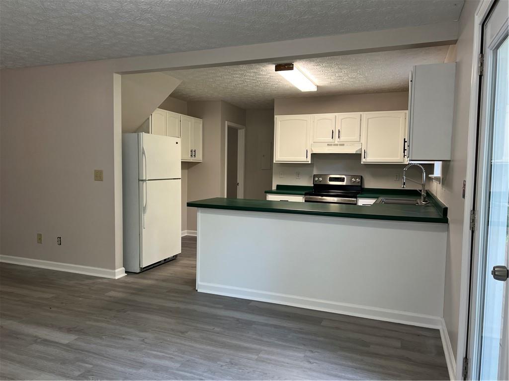 129 Pine Road Dahlonega, GA 30533 - Photo 14 of 27 a kitchen with a refrigerator a stove and wooden floor