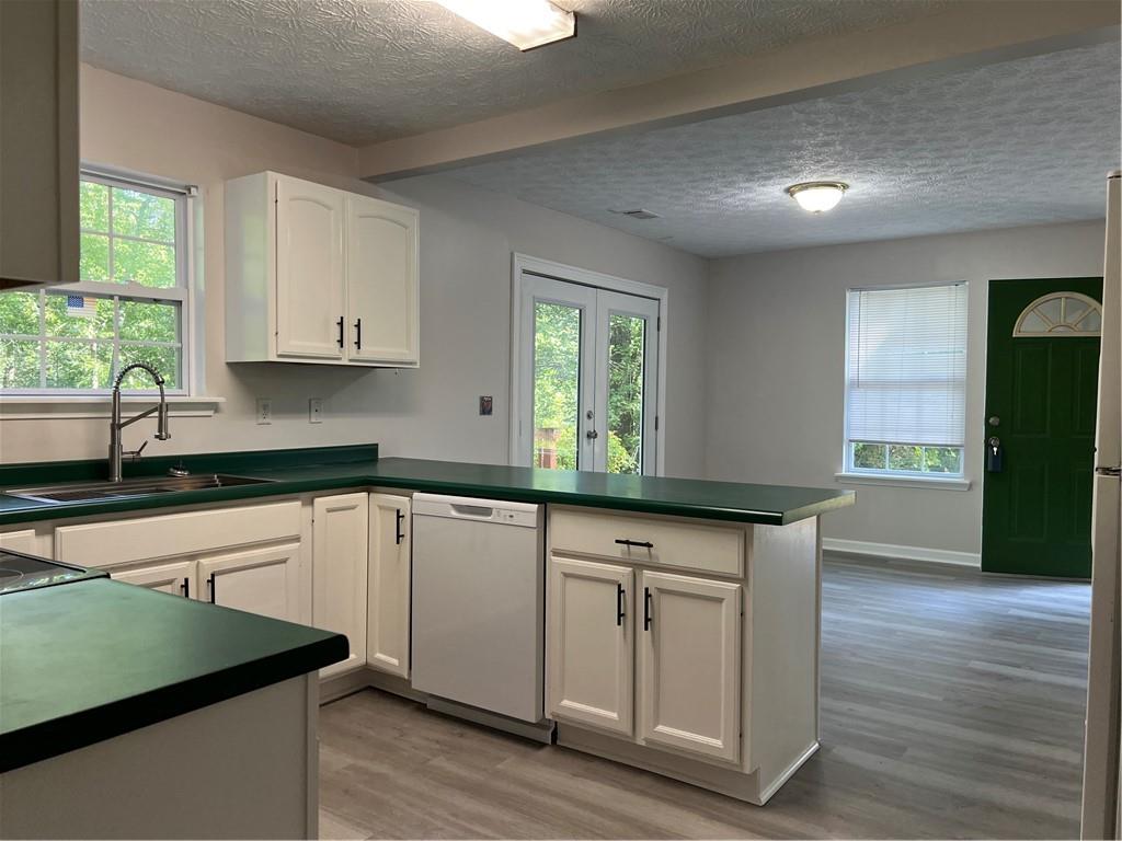 129 Pine Road Dahlonega, GA 30533 - Photo 15 of 27 a kitchen with granite countertop a sink cabinets and wooden floor