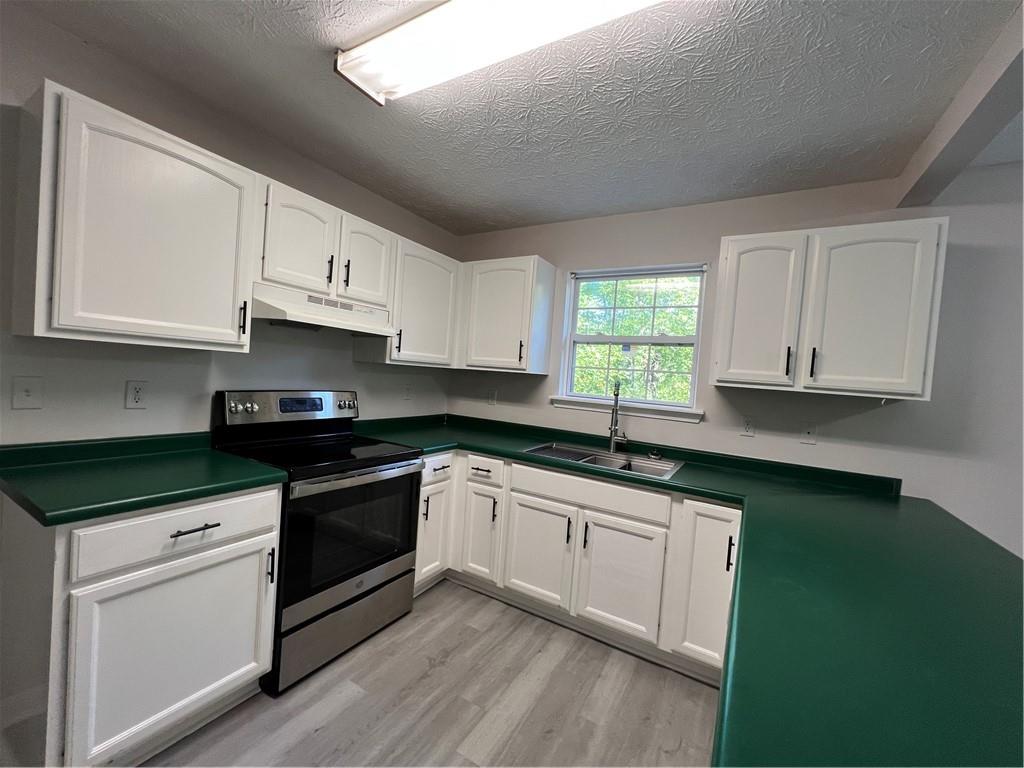 129 Pine Road Dahlonega, GA 30533 - Photo 16 of 27 a kitchen with granite countertop a sink cabinets and stainless steel appliances
