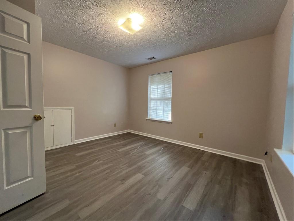 129 Pine Road Dahlonega, GA 30533 - Photo 18 of 27 an empty room with wooden floor and windows