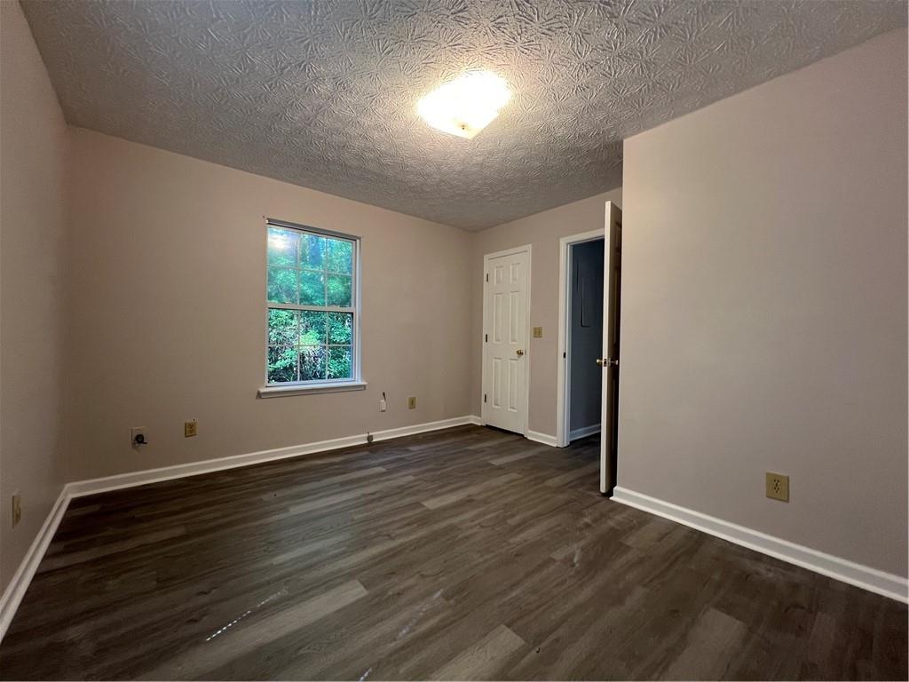 129 Pine Road Dahlonega, GA 30533 - Photo 19 of 27 an empty room with wooden floor and windows