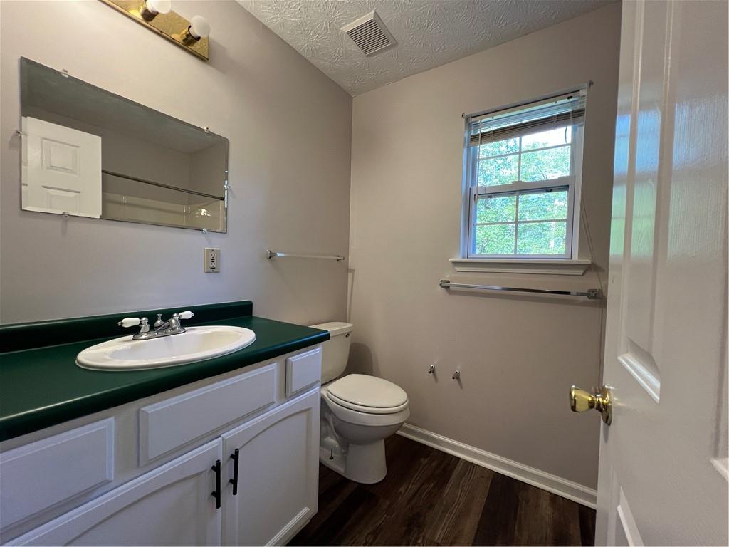 129 Pine Road Dahlonega, GA 30533 - Photo 24 of 27 a bathroom with a granite countertop toilet sink and mirror