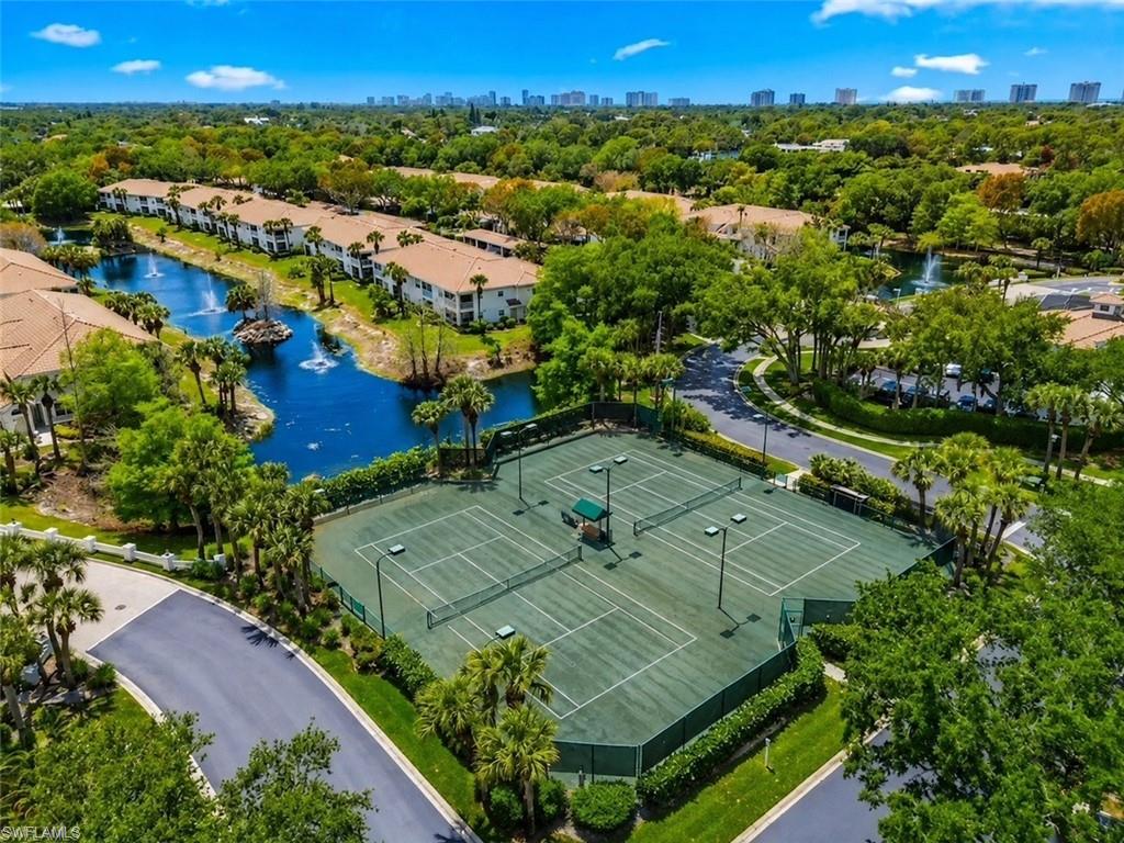 6812 Satinleaf Road South, Unit 202 Naples, FL 34109 - Photo 34 of 35 Three tennis courts, lush perimeter landscaping, and a manicured road system