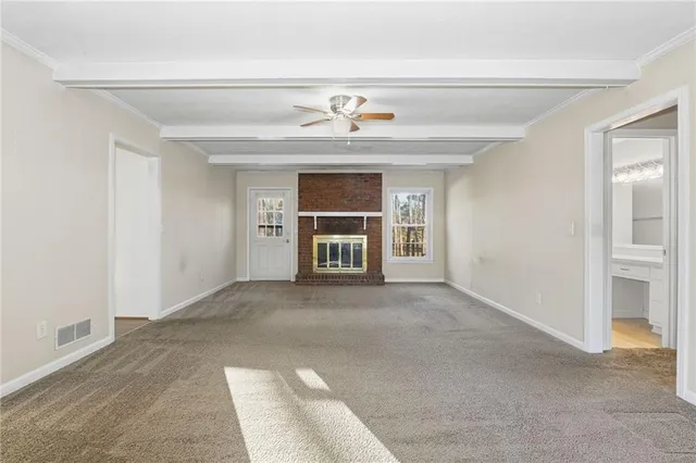 a view of empty room with a fireplace