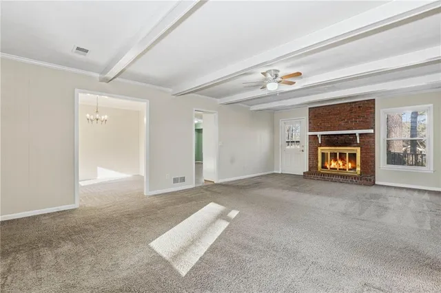 a view of empty room with a fireplace