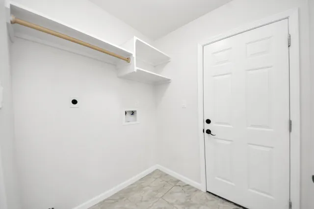 an empty room with a window and a ceiling fan