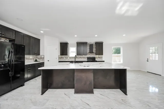 a large kitchen with stainless steel appliances lots of counter top space